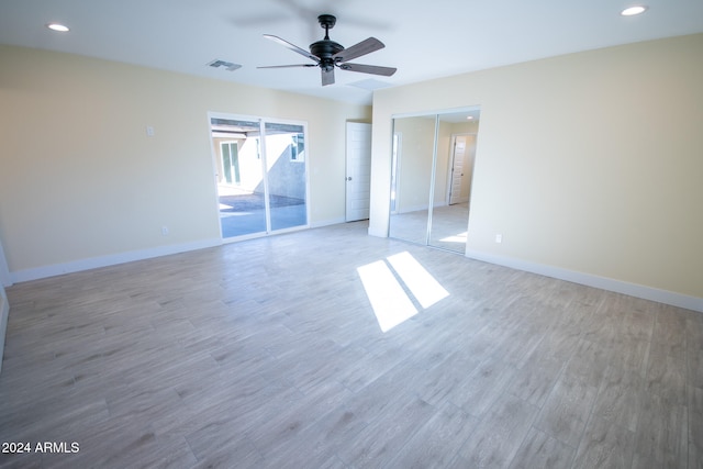 spare room with hardwood / wood-style floors and ceiling fan