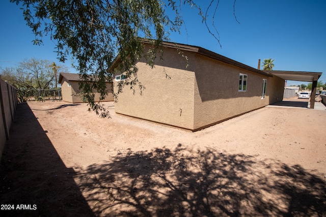 rear view of property with a carport