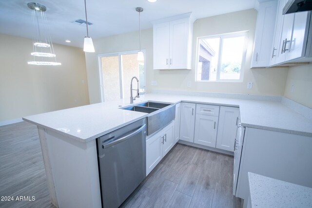 kitchen with white cabinets, light hardwood / wood-style flooring, hanging light fixtures, and sink