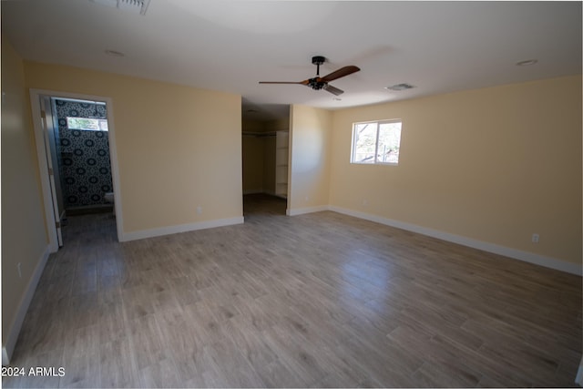 empty room with ceiling fan and wood-type flooring