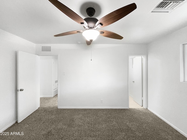 unfurnished room featuring baseboards, visible vents, a ceiling fan, and carpet