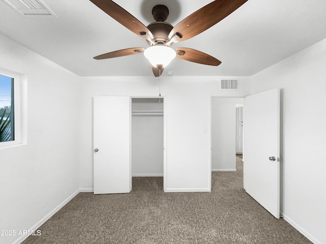 unfurnished bedroom with carpet flooring, baseboards, and visible vents