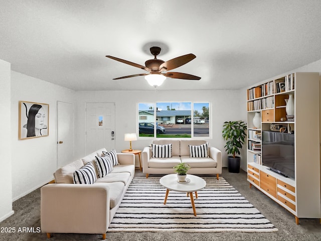 living room with dark colored carpet and a ceiling fan