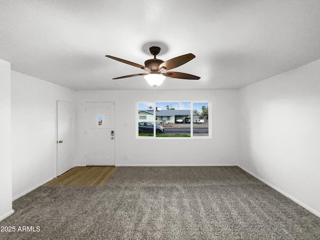 interior space with carpet flooring, baseboards, and ceiling fan