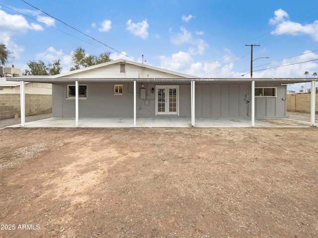 rear view of house with a patio, french doors, and fence