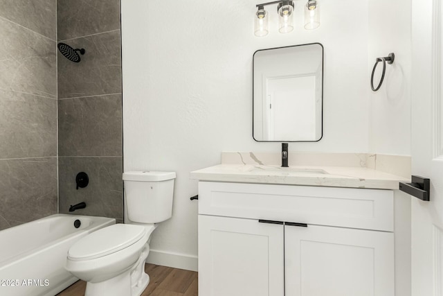 full bath with shower / bathtub combination, toilet, vanity, wood finished floors, and baseboards