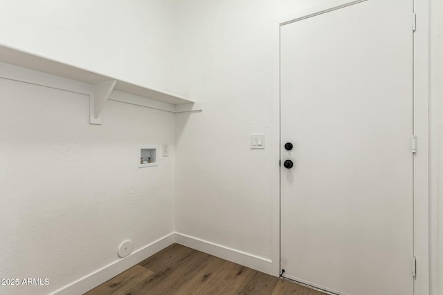 clothes washing area featuring laundry area, baseboards, washer hookup, and wood finished floors