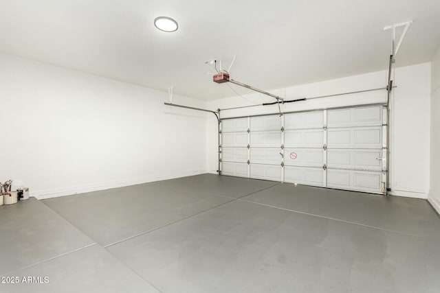 garage with a garage door opener and baseboards