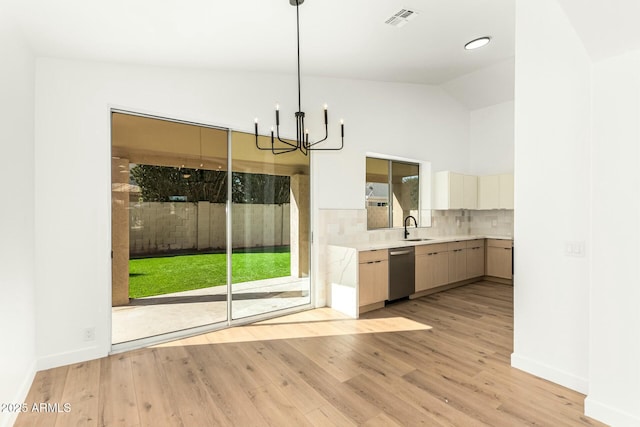 interior space featuring visible vents, light wood-style flooring, light countertops, stainless steel dishwasher, and a sink