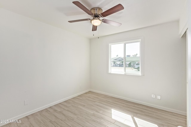 empty room featuring light wood-style flooring, baseboards, and ceiling fan