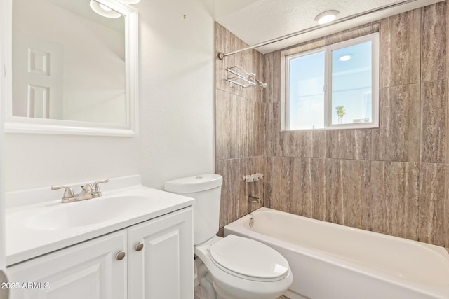 bathroom with washtub / shower combination, vanity, and toilet