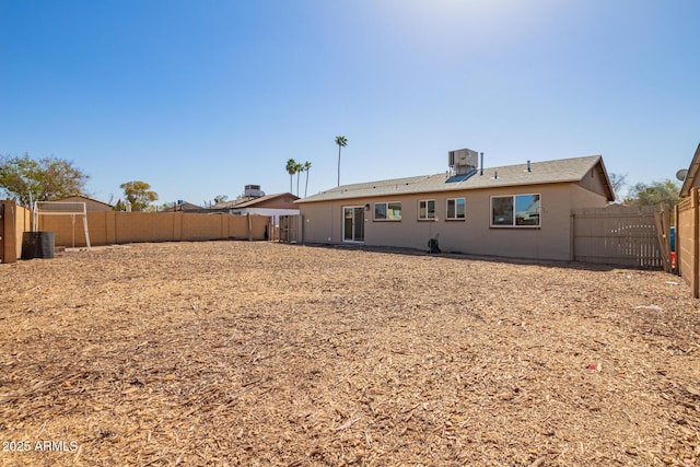 rear view of property featuring a fenced backyard