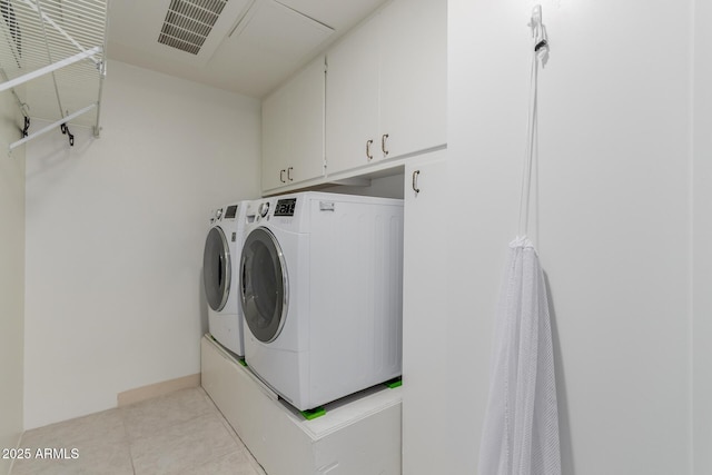 10330 W Thunderbird Blvd Unit C109, Sun City, AZ 85351 - laundry area featuring washer and dryer, cabinet space, and light tile patterned floors