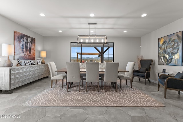 dining area featuring baseboards, recessed lighting, and an inviting chandelier