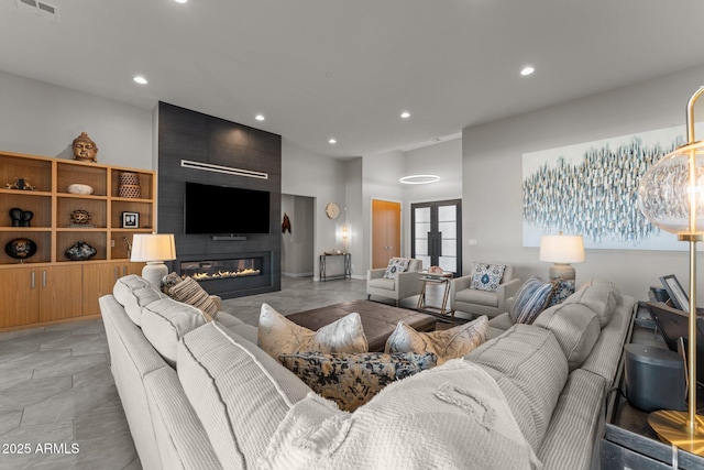 living area featuring a fireplace, visible vents, and recessed lighting