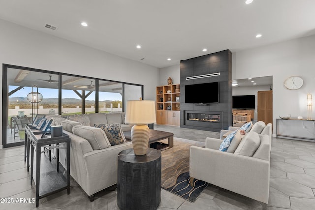 living area featuring a ceiling fan, recessed lighting, visible vents, and a fireplace