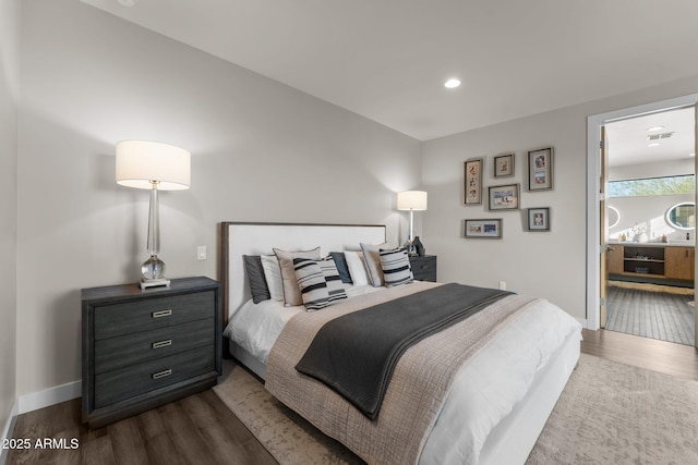 bedroom featuring baseboards, dark wood finished floors, and recessed lighting