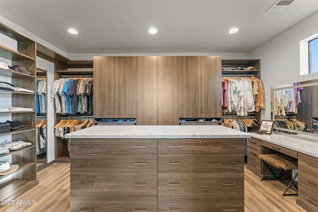 walk in closet featuring visible vents and light wood-style flooring