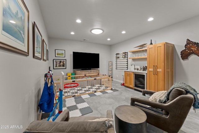 living room featuring beverage cooler, visible vents, indoor wet bar, and recessed lighting