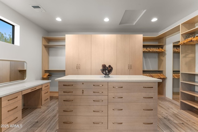 walk in closet with light wood-type flooring and visible vents