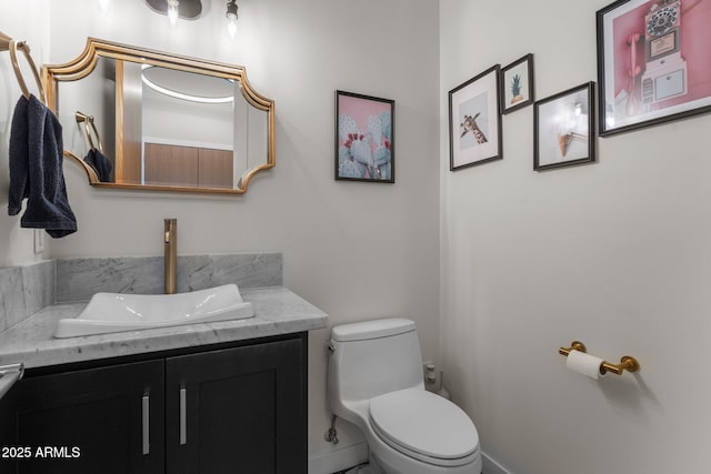 bathroom with toilet and vanity