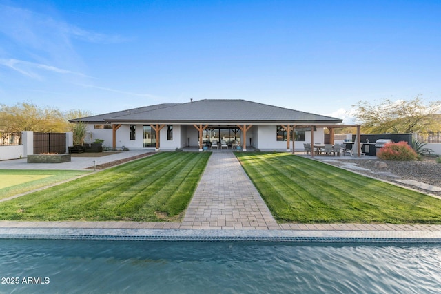 back of house featuring a yard, a patio area, and fence