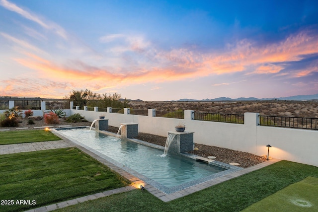 pool at dusk featuring a fenced in pool, a fenced backyard, a yard, central air condition unit, and a mountain view