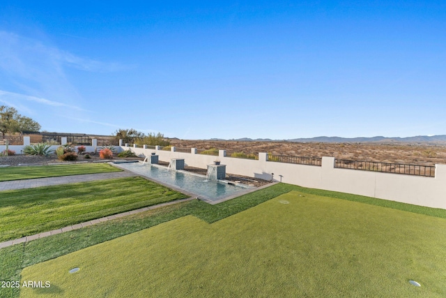 view of yard featuring fence and a mountain view