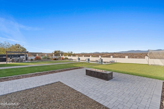 exterior space featuring an outdoor fire pit, a mountain view, fence, a pergola, and a patio area