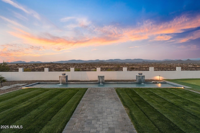 view of yard with fence and a mountain view