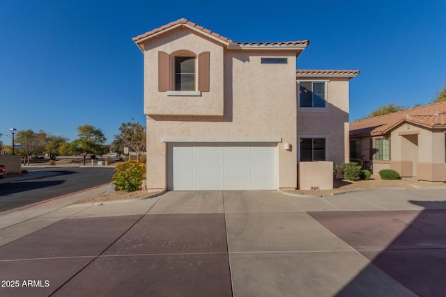 mediterranean / spanish-style home with a garage