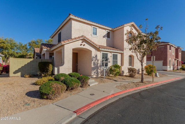 mediterranean / spanish house featuring a garage