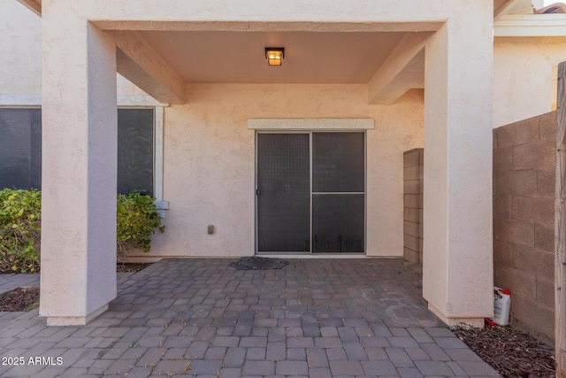 entrance to property with a patio