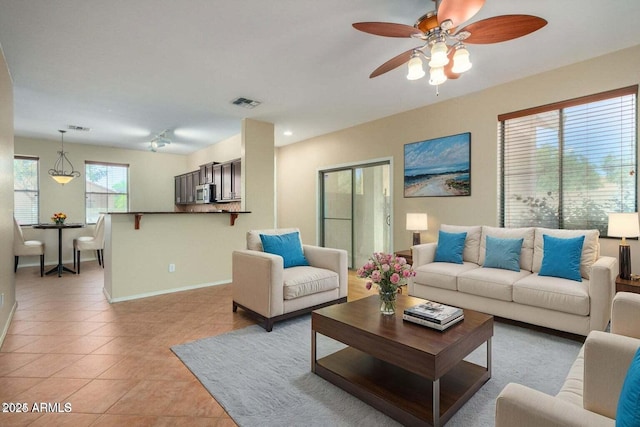 tiled living room featuring ceiling fan