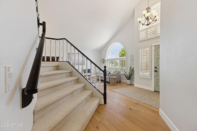 2258 N Gentry, Mesa, AZ 85213 - entrance foyer with a chandelier, high vaulted ceiling, wood finished floors, and stairs