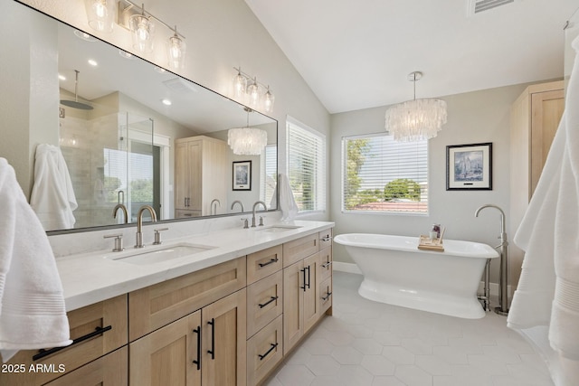 2258 N Gentry, Mesa, AZ 85213 - full bath featuring a chandelier, a stall shower, lofted ceiling, double vanity, and a freestanding tub