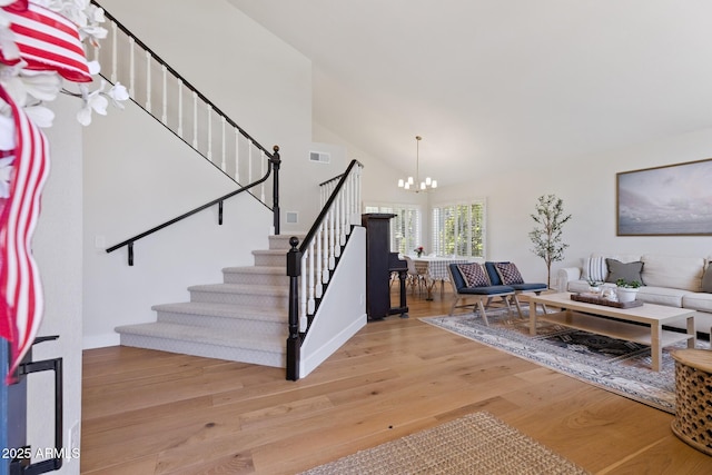 2258 N Gentry, Mesa, AZ 85213 - staircase with a chandelier, wood finished floors, and high vaulted ceiling