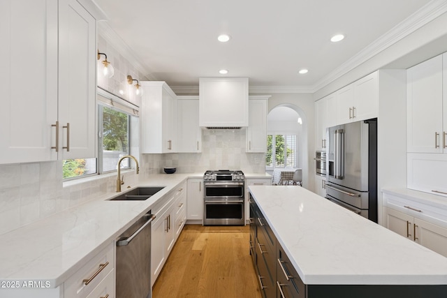 2258 N Gentry, Mesa, AZ 85213 - kitchen with premium appliances, custom exhaust hood, a kitchen island, healthy amount of natural light, and recessed lighting