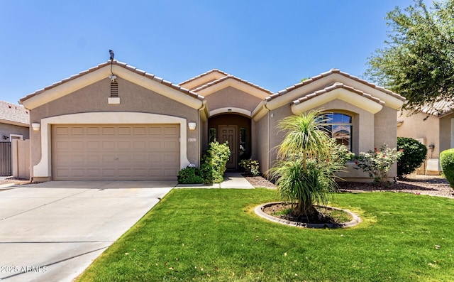 mediterranean / spanish home with a tiled roof, driveway, a front yard, and a garage