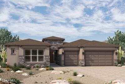 prairie-style house featuring an attached garage, stone siding, decorative driveway, and stucco siding