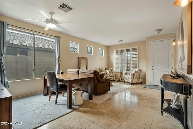 dining space featuring ceiling fan and light tile patterned flooring