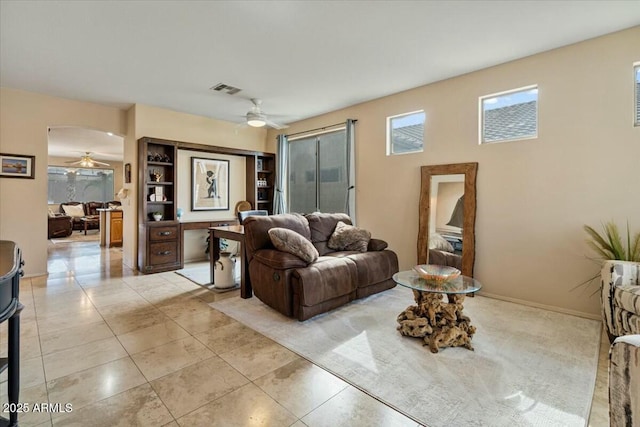 living room with ceiling fan and light tile patterned floors