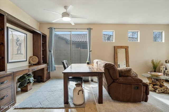 tiled office featuring ceiling fan