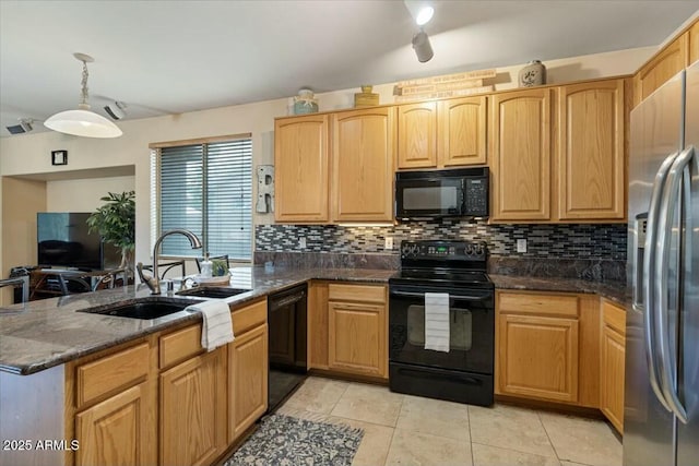 kitchen with backsplash, dark stone countertops, black appliances, sink, and light tile patterned floors