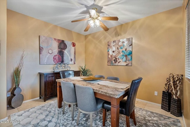 dining area featuring ceiling fan and light tile patterned floors