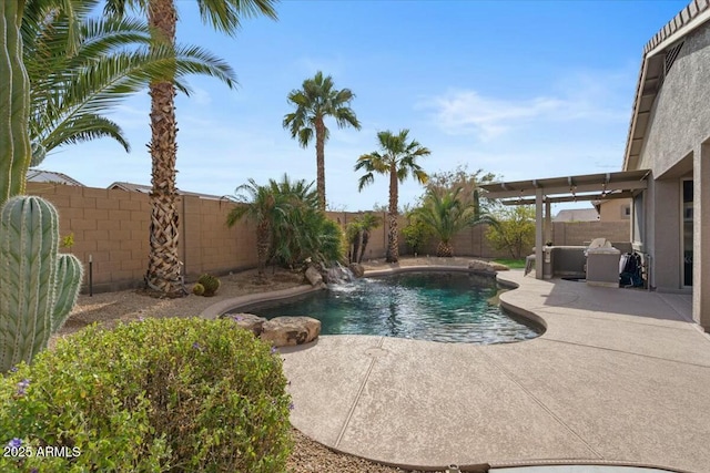 view of pool with pool water feature and a patio