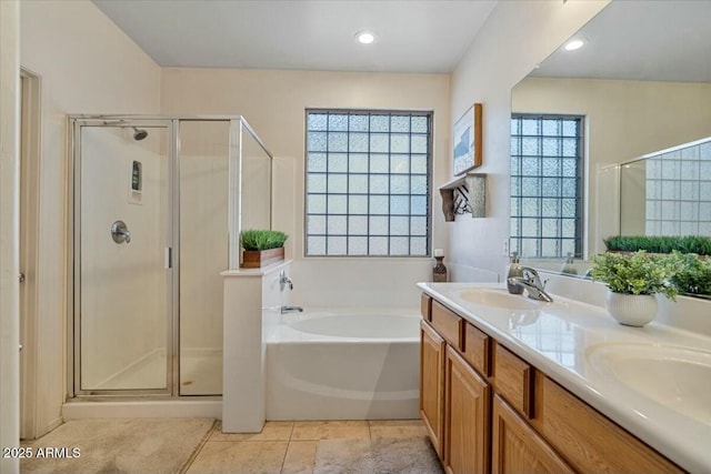 bathroom featuring tile patterned floors, separate shower and tub, and vanity