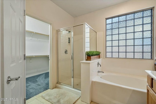 bathroom featuring vanity, separate shower and tub, and tile patterned flooring