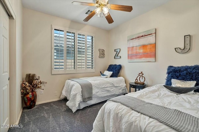 carpeted bedroom featuring ceiling fan and a closet