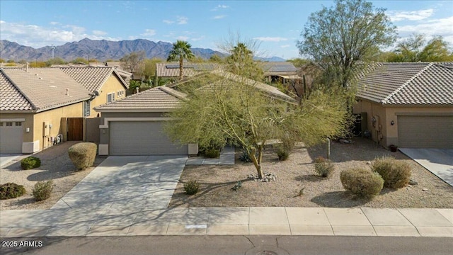 view of front of property with a mountain view and a garage